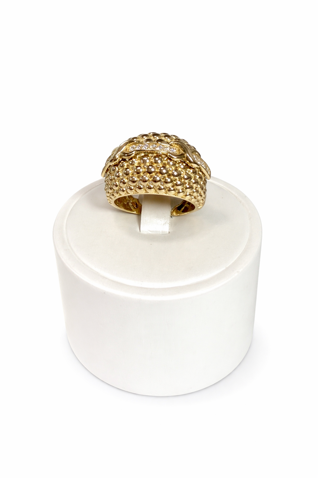 Women's ring in 10K gold with a textured dome design and sparkling details.