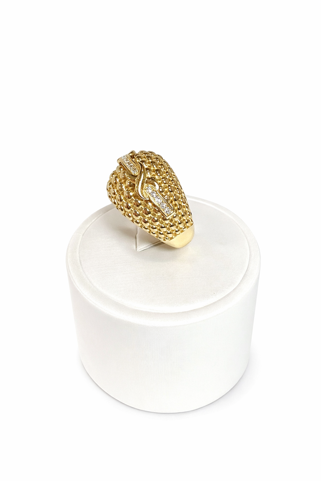 Women's ring in 10K gold with a textured dome design and sparkling details.